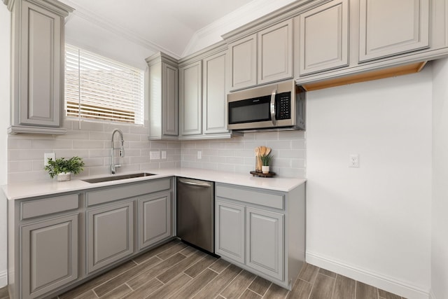 6518 Fairway Glen Ln, Katy, TX 77493 - kitchen with a sink, stainless steel appliances, ornamental molding, wood finished floors, and gray cabinets