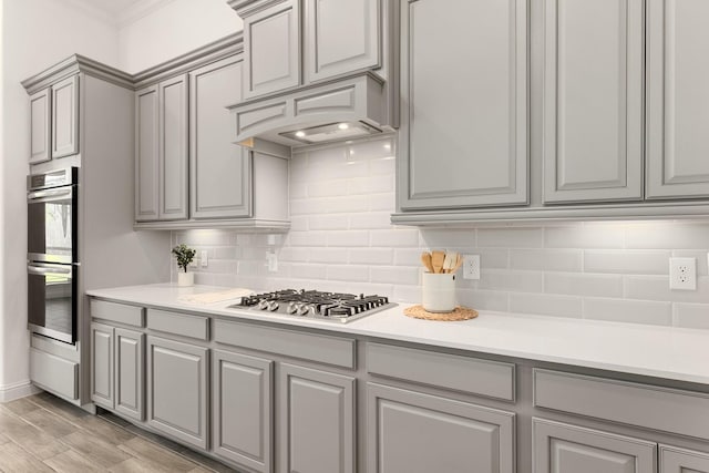 6518 Fairway Glen Ln, Katy, TX 77493 - kitchen featuring gray cabinets, backsplash, and appliances with stainless steel finishes