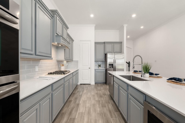 6518 Fairway Glen Ln, Katy, TX 77493 - kitchen with a sink, wine cooler, backsplash, ornamental molding, and gray cabinetry