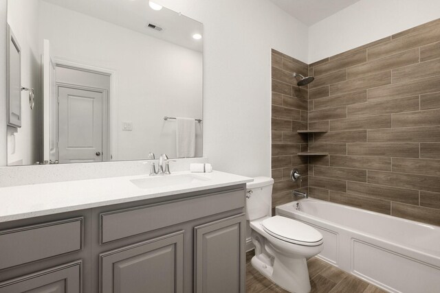 6518 Fairway Glen Ln, Katy, TX 77493 - full bath with vanity, shower / bath combination, toilet, visible vents, and wood finished floors