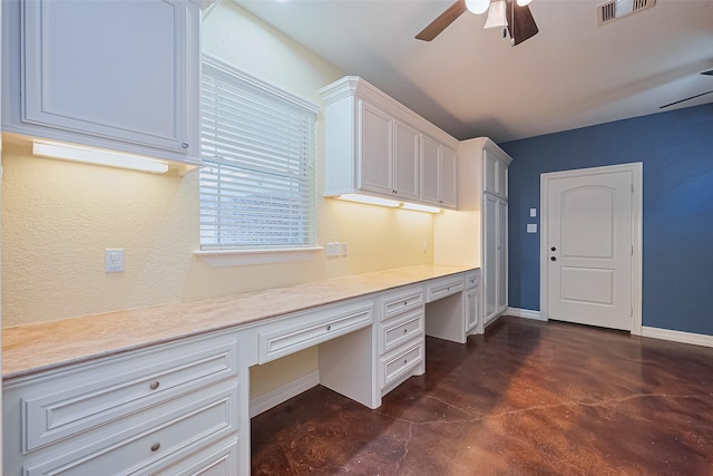 unfurnished office with baseboards, built in study area, a ceiling fan, visible vents, and finished concrete floors