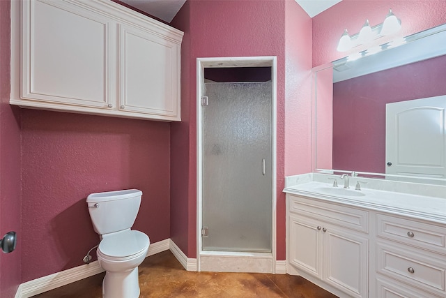 bathroom with toilet, a shower stall, vanity, and baseboards