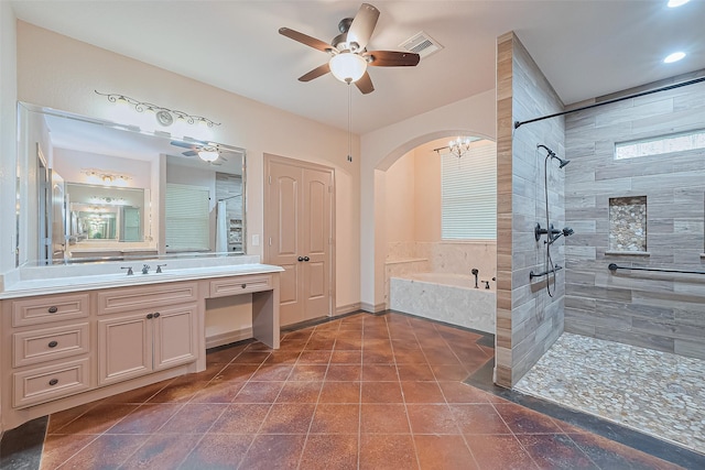 bathroom featuring visible vents, a bath, ceiling fan, vanity, and tiled shower