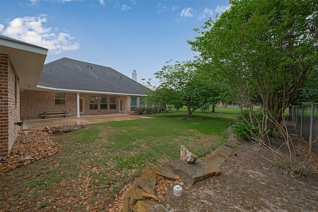 view of yard featuring a patio and fence