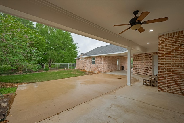 view of patio with fence and a ceiling fan