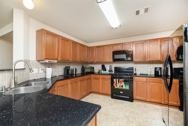 22110 Orchard Dale Dr, Spring, TX 77389 - kitchen with black appliances, visible vents, brown cabinetry, decorative backsplash, and a sink