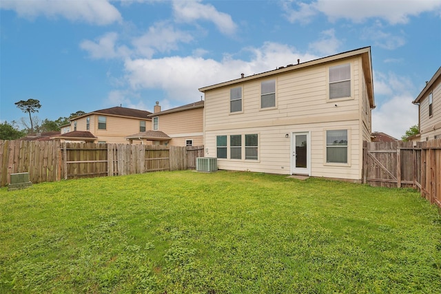 22110 Orchard Dale Dr, Spring, TX 77389 - back of house with central AC unit, a fenced backyard, and a lawn