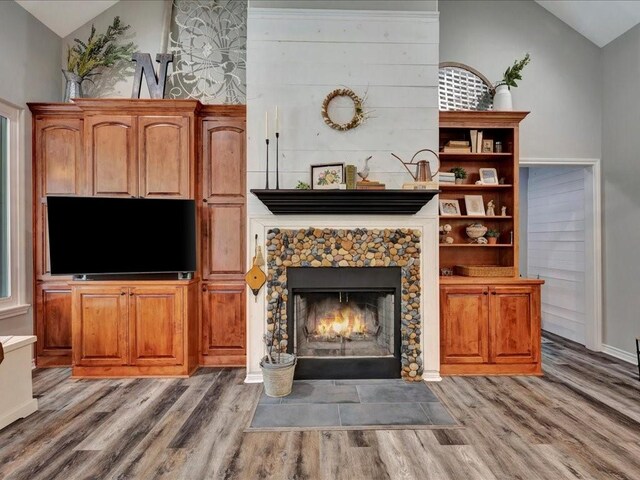 3065 S Fm 1194, Lufkin, TX 75904 - unfurnished living room featuring vaulted ceiling, light wood-style flooring, and a fireplace