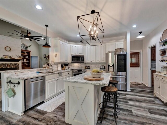 3065 S Fm 1194, Lufkin, TX 75904 - kitchen featuring backsplash, a sink, white cabinetry, dark wood finished floors, and stainless steel appliances