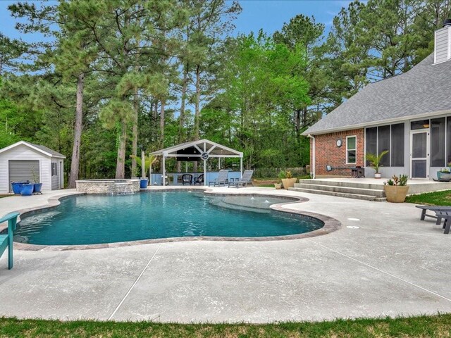 3065 S Fm 1194, Lufkin, TX 75904 - view of swimming pool with a pool with connected hot tub, a gazebo, an outbuilding, a sunroom, and a patio