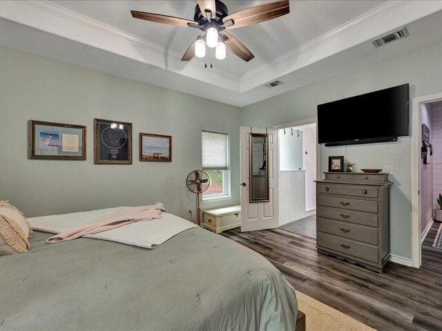 3065 S Fm 1194, Lufkin, TX 75904 - bedroom featuring a raised ceiling, ornamental molding, dark wood-style floors, and visible vents