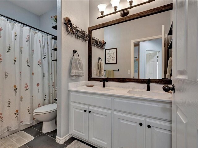 3065 S Fm 1194, Lufkin, TX 75904 - bathroom featuring double vanity, a sink, toilet, and tile patterned floors