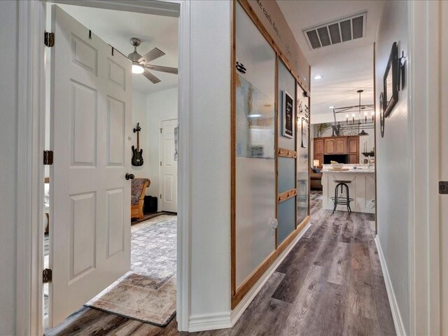 3065 S Fm 1194, Lufkin, TX 75904 - corridor featuring dark wood-style floors, visible vents, a notable chandelier, and baseboards