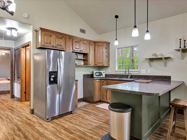 3065 S Fm 1194, Lufkin, TX 75904 - kitchen with open shelves, stainless steel fridge with ice dispenser, dark countertops, visible vents, and a peninsula