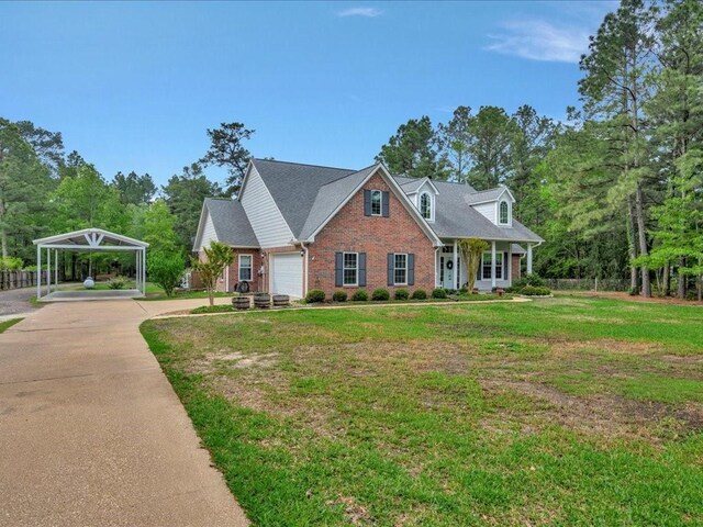 3065 S Fm 1194, Lufkin, TX 75904 - view of front facade featuring driveway, a front yard, an attached garage, brick siding, and a carport