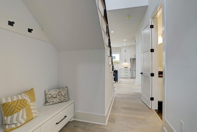 mudroom with light wood-style floors, recessed lighting, and baseboards