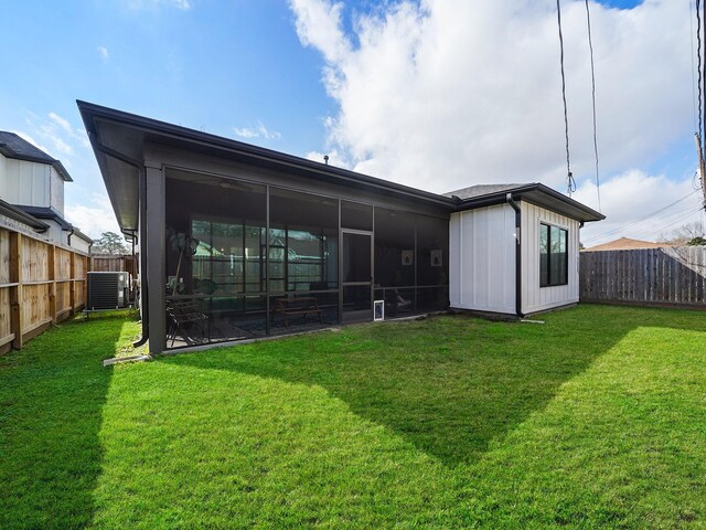 rear view of house featuring a sunroom and central AC unit
