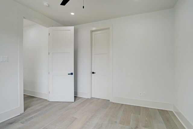 unfurnished bedroom featuring light wood-style flooring, recessed lighting, and baseboards
