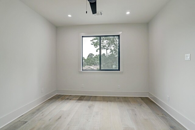 spare room with light wood-style floors, recessed lighting, and baseboards