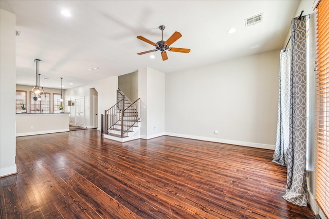 unfurnished living room with ceiling fan, dark wood-style floors, and visible vents