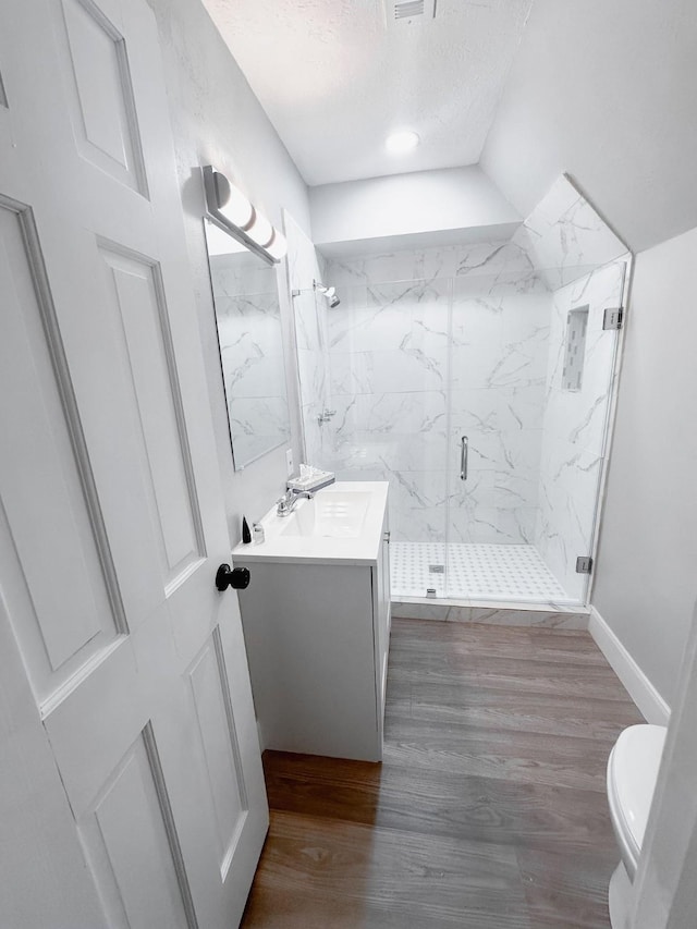 537 Natchez Park, Conroe, TX 77302 - bathroom with vanity, a marble finish shower, toilet, wood finished floors, and a textured ceiling