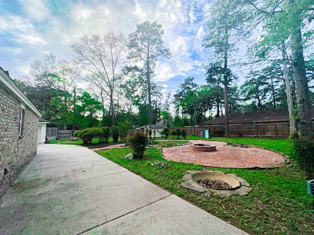 537 Natchez Park, Conroe, TX 77302 - view of yard featuring a fire pit and a patio area