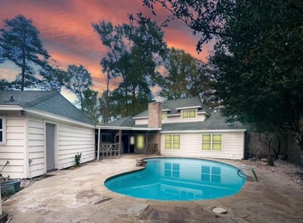 537 Natchez Park, Conroe, TX 77302 - pool at dusk with a patio area, an outdoor pool, and fence