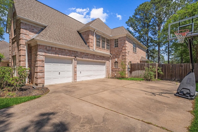 5206 Summer Snow Dr, Houston, TX 77041 - view of side of home with brick siding, fence, roof with shingles, and concrete driveway