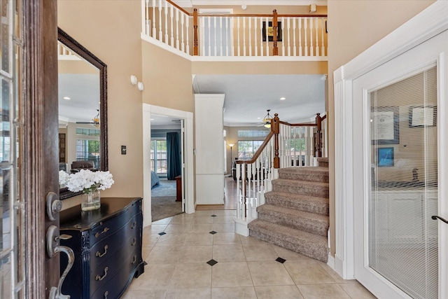 5206 Summer Snow Dr, Houston, TX 77041 - carpeted foyer with stairway, tile patterned floors, ceiling fan, baseboards, and a towering ceiling