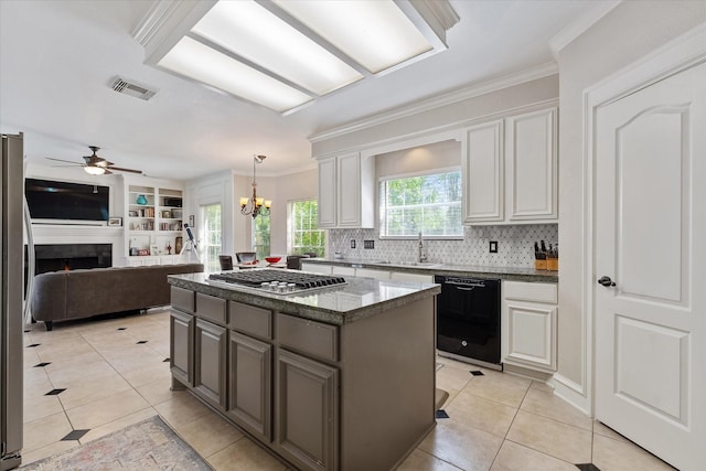 5206 Summer Snow Dr, Houston, TX 77041 - kitchen with black dishwasher, stainless steel gas stovetop, ceiling fan, crown molding, and light tile patterned floors