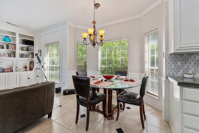 5206 Summer Snow Dr, Houston, TX 77041 - dining area featuring a chandelier, ornamental molding, light tile patterned floors, a wainscoted wall, and plenty of natural light
