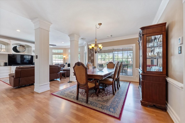 5206 Summer Snow Dr, Houston, TX 77041 - dining area featuring decorative columns, crown molding, a chandelier, light wood-style floors, and a wainscoted wall