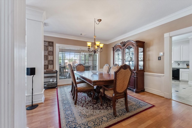 5206 Summer Snow Dr, Houston, TX 77041 - dining room with light wood-type flooring, a chandelier, ornamental molding, and a wainscoted wall