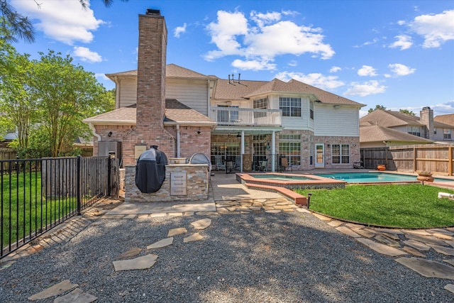 5206 Summer Snow Dr, Houston, TX 77041 - back of property featuring an in-ground hot tub, a patio area, a chimney, a shingled roof, and brick siding