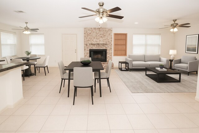 3903 Dolphin Ln, La Porte, TX 77571 - dining room with a ceiling fan, built in features, a large fireplace, and light tile patterned flooring