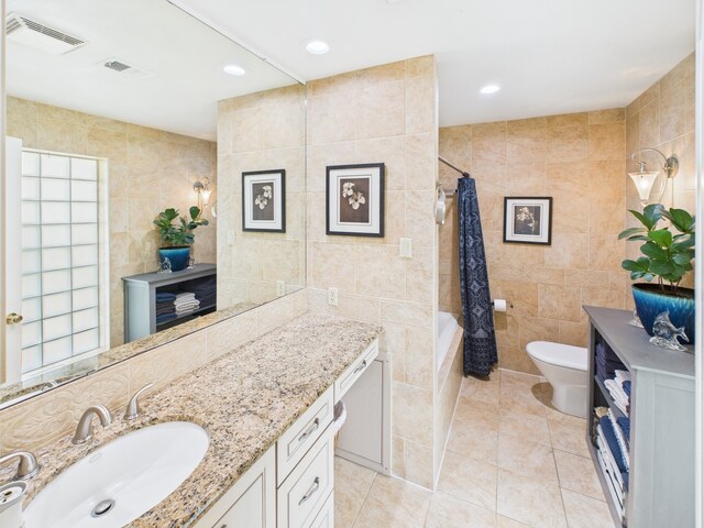 1310 Golden Bear Ln, Kingwood, TX 77339 - bathroom featuring tile walls, toilet, tile patterned flooring, vanity, and tiled shower / bath