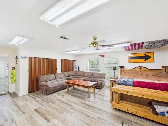 1310 Golden Bear Ln, Kingwood, TX 77339 - living area featuring light wood-style flooring and a ceiling fan