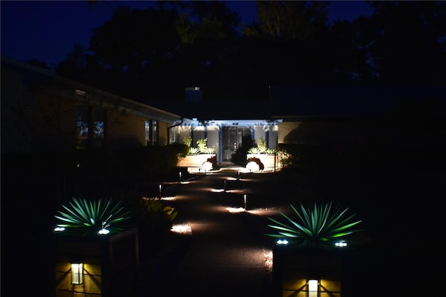 1310 Golden Bear Ln, Kingwood, TX 77339 - yard at night featuring a patio