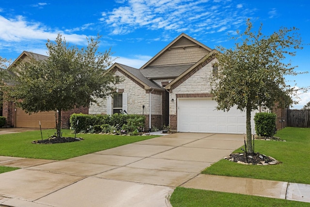 view of front facade with stone siding, driveway, a garage, and a front lawn