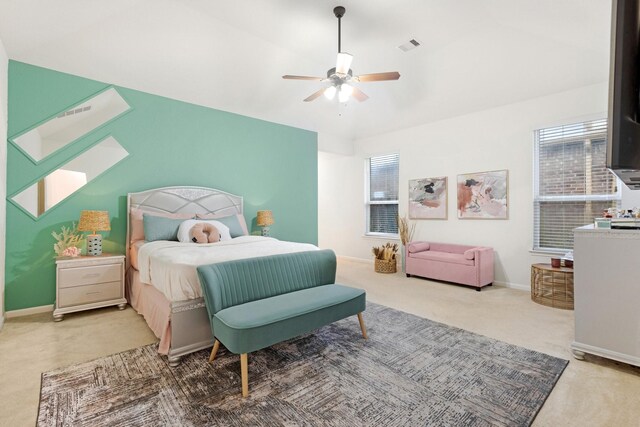 carpeted bedroom with baseboards, visible vents, and a ceiling fan