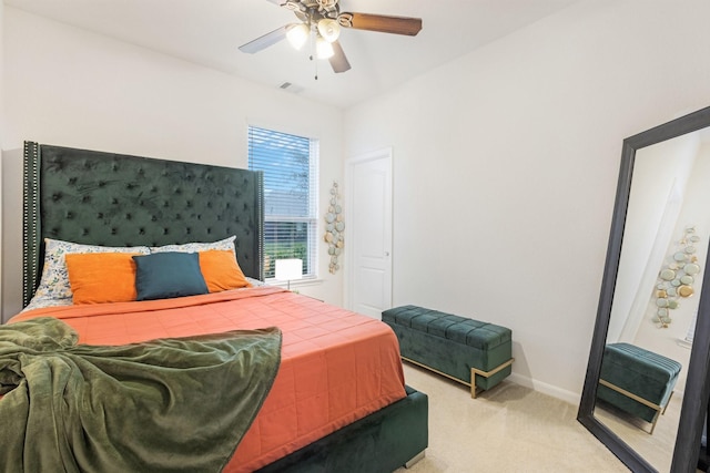 bedroom with baseboards, visible vents, a ceiling fan, and light colored carpet