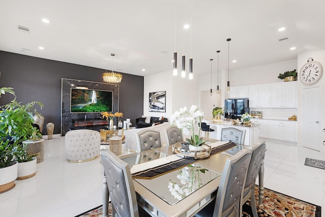 dining space featuring light tile patterned flooring, visible vents, a chandelier, and recessed lighting