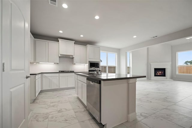 kitchen with marble finish floor, visible vents, dark countertops, and appliances with stainless steel finishes
