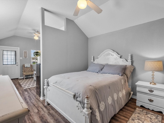 bedroom featuring baseboards, vaulted ceiling, wood finished floors, and a ceiling fan