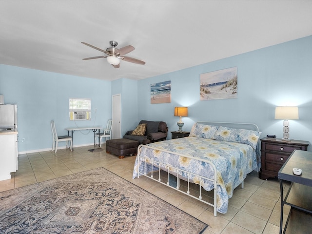 bedroom with baseboards, ceiling fan, light tile patterned floors, and freestanding refrigerator