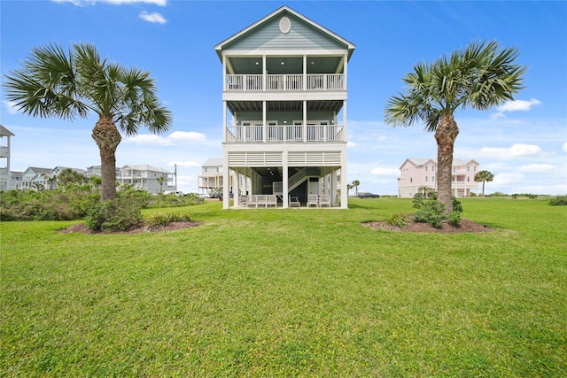 26711 Bay Water Dr, Galveston, TX 77554 - back of property featuring a yard and a balcony