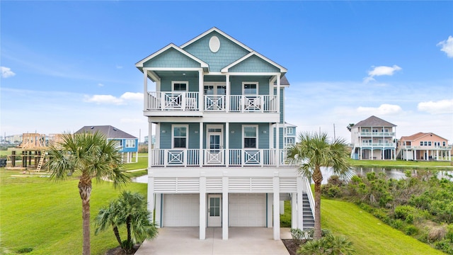 26711 Bay Water Dr, Galveston, TX 77554 - beach home featuring driveway, an attached garage, a front lawn, and a porch