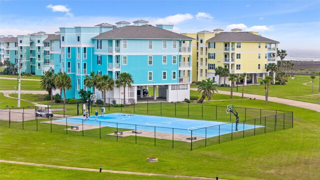 26711 Bay Water Dr, Galveston, TX 77554 - exterior space with community basketball court, fence, and a lawn