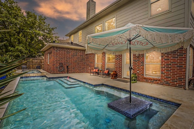 view of pool featuring a patio area, a fenced in pool, and fence
