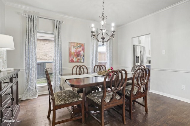 dining room featuring dark wood-type flooring, a notable chandelier, ornamental molding, and baseboards